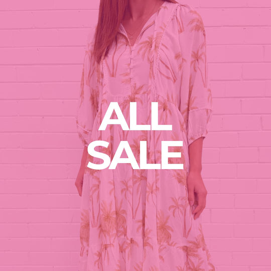 Stylish brown blouse paired with a cozy cream vest featuring floral embroidery, ideal for fall fashion.